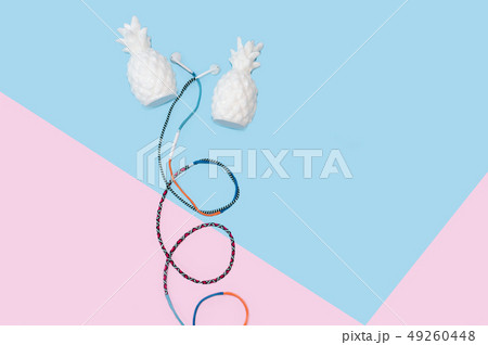 Colorful hippy earbud headphones on pastel blue background with copy space 49260448