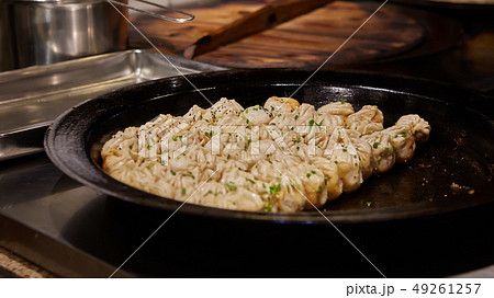big frying pan with sheng jian bao-traditional chinese pan fried dumplings with minced pork shrimp 49261257