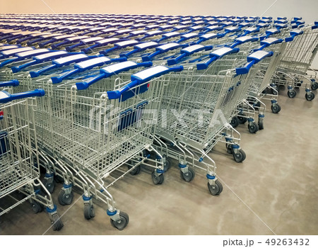Rows of shopping carts collected in supermarket. Rows of shopping carts collected in supermarket. 49263432