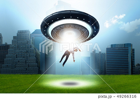 Flying saucer abducting young businessman  49266316