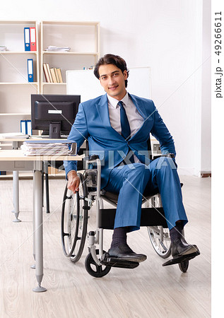 Male employee in wheelchair working at the office  49266611
