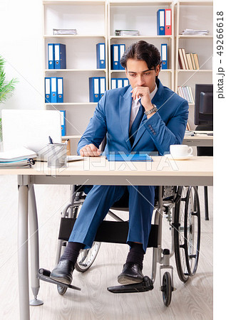 Male employee in wheelchair working at the office  49266618