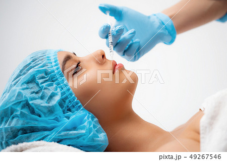 The doctor cosmetologist makes the Rejuvenating facial injections procedure for tightening and 49267546