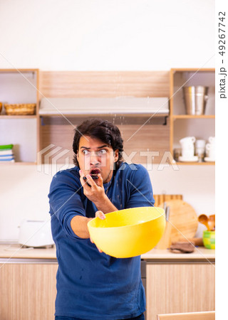 Young man in water leakage from the neighbors concept Young man in water leakage from the neighbors concept 49267742