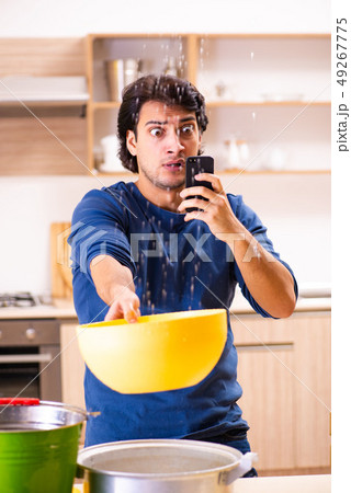 Young man in water leakage from the neighbors concept Young man in water leakage from the neighbors concept 49267775