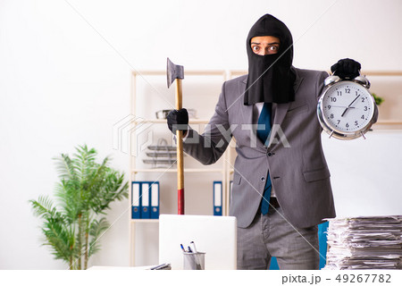 Male gangster stealing information from the office Male gangster stealing information from the office 49267782