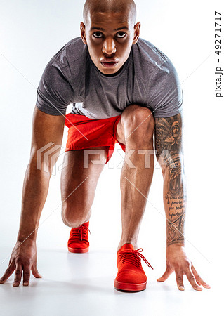 Sportive man starting to run from a low Sportive man starting to run from a low 49271717