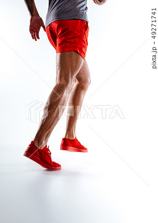 Mans figure wearing red shorts performing running movements Mans figure wearing red shorts performing running movements 49271741
