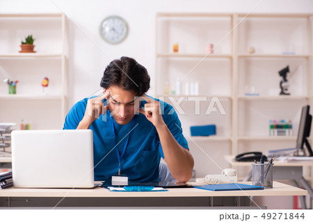 Young handsome doctor working in the clinic  49271844