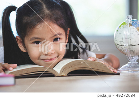 Back to school. Cute asian child girl with a book Back to school. Cute asian child girl with a book 49272634