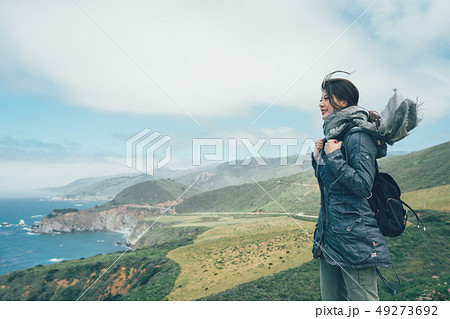 girl backpacker with scarf flying in wind girl backpacker with scarf flying in wind 49273692