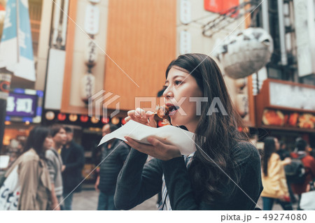 female model eating octopus ball dumpling female model eating octopus ball dumpling 49274080