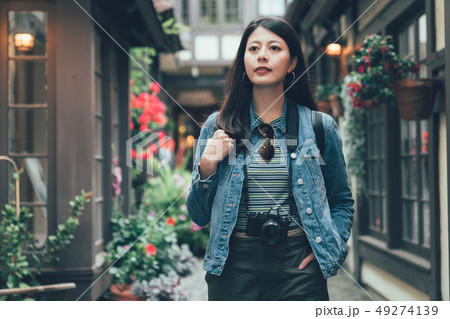 traveler walking path surrounding blossom flowers 49274139