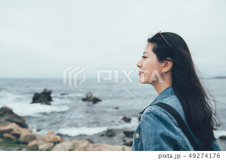 happy girl tourist on cliff overlooking ocean happy girl tourist on cliff overlooking ocean 49274176