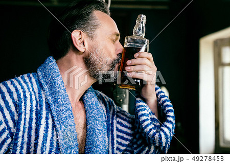 Close Up of a Brutal Beard With a Bottle of His Favorite Whiskey. Close Up of a Brutal Beard With a Bottle of His Favorite Whiskey. 49278453