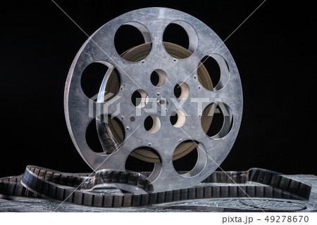35 mm film reel with dramatic lighting on a dark 49278670