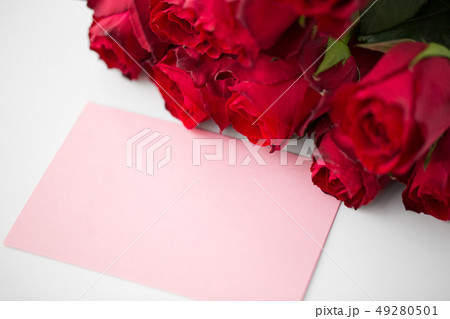 close up of red roses and letter or note 49280501