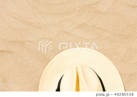 straw hat on beach sand 49280558