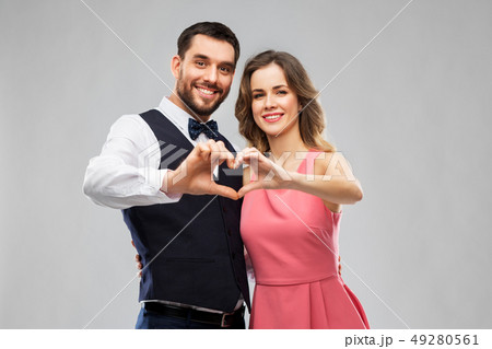 happy couple making hand heart on valentines day 49280561