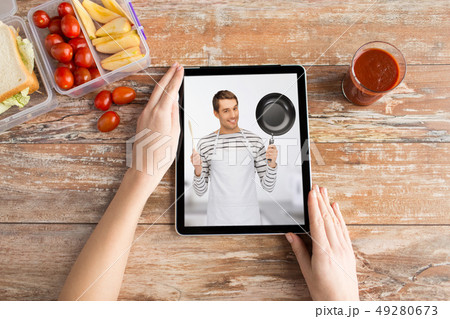 woman watching cooking video on tablet computer 49280673