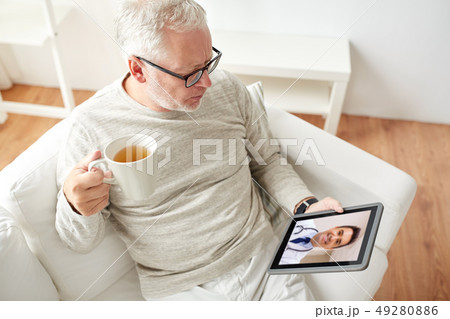 senior man having video call with doctor on tablet 49280886