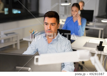 man with computer working at night office man with computer working at night office 49281087