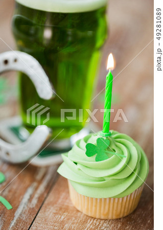 green cupcake with candle, beer and horseshoe green cupcake with candle, beer and horseshoe 49281089