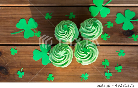 green cupcakes and shamrock on wooden table green cupcakes and shamrock on wooden table 49281275