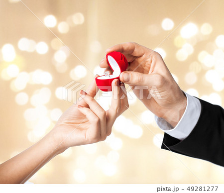 man giving diamond ring to woman on valentines day man giving diamond ring to woman on valentines day 49281277