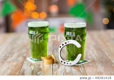 glasses of green beer, horseshoe and gold coins glasses of green beer, horseshoe and gold coins 49281419