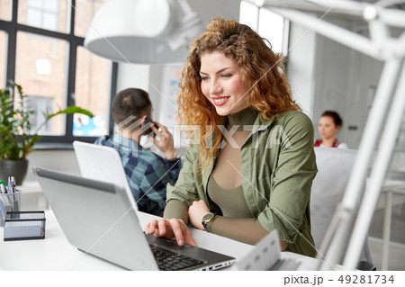 happy woman with computer working at office happy woman with computer working at office 49281734