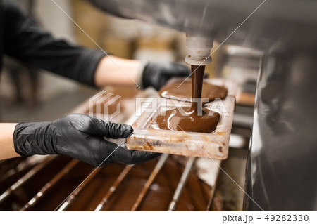 confectioner makes chocolate candies at sweet-shop 49282330
