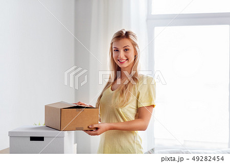 happy woman with boxes moving to new home happy woman with boxes moving to new home 49282454