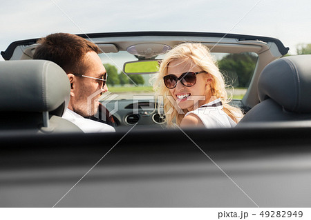 happy man and woman driving in cabriolet car 49282949