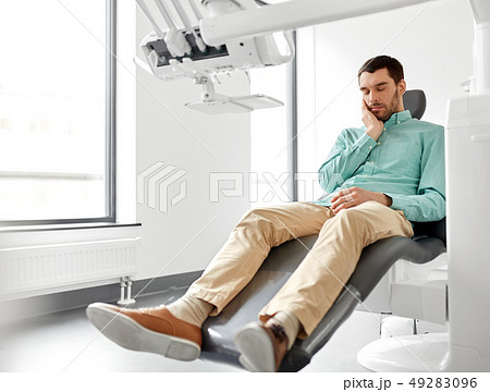 patient suffering from toothache at dental clinic 49283096