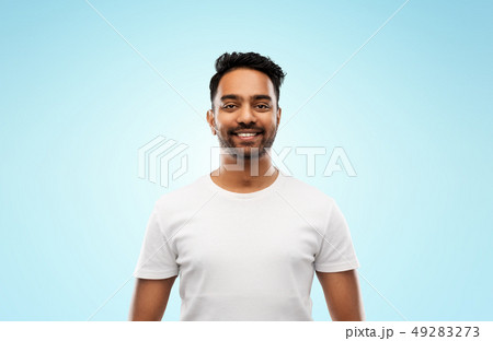 smiling young indian man over blue background smiling young indian man over blue background 49283273