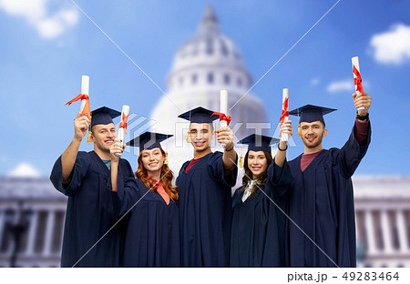 graduates in mortar boards with diplomas 49283464