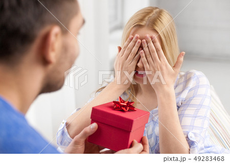 happy couple with gift box at home 49283468