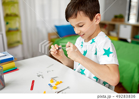little boy playing with building kit at home little boy playing with building kit at home 49283836