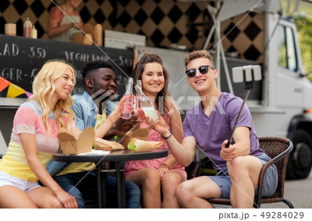 happy young friends taking selfie at food truck 49284029