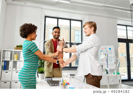 happy creative team making high five at office 49284182