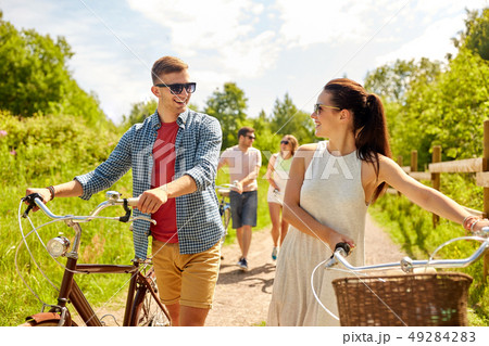 happy couple with bicycles at summer park 49284283