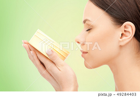 beautiful woman smelling moisturizing cream aroma beautiful woman smelling moisturizing cream aroma 49284403