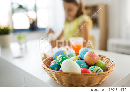 colored easter eggs and girl on background at home colored easter eggs and girl on background at home 49284455