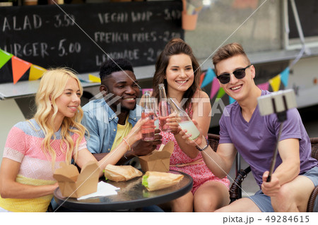 happy young friends taking selfie at food truck 49284615