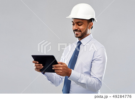 architect or businessman in helmet with tablet pc architect or businessman in helmet with tablet pc 49284776