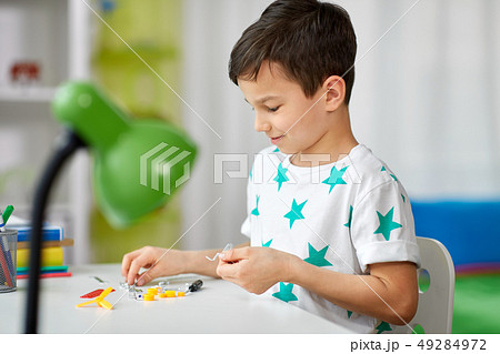 little boy playing with building kit at home little boy playing with building kit at home 49284972