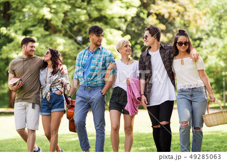 friends with guitar and picnic blanket at park friends with guitar and picnic blanket at park 49285063