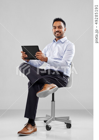 indian businessman with tablet pc on office chair 49285191