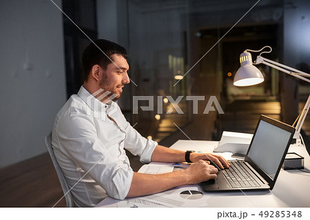 businessman with laptop working at night office 49285348